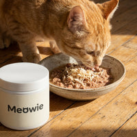 Cat eating food topped with Meowie